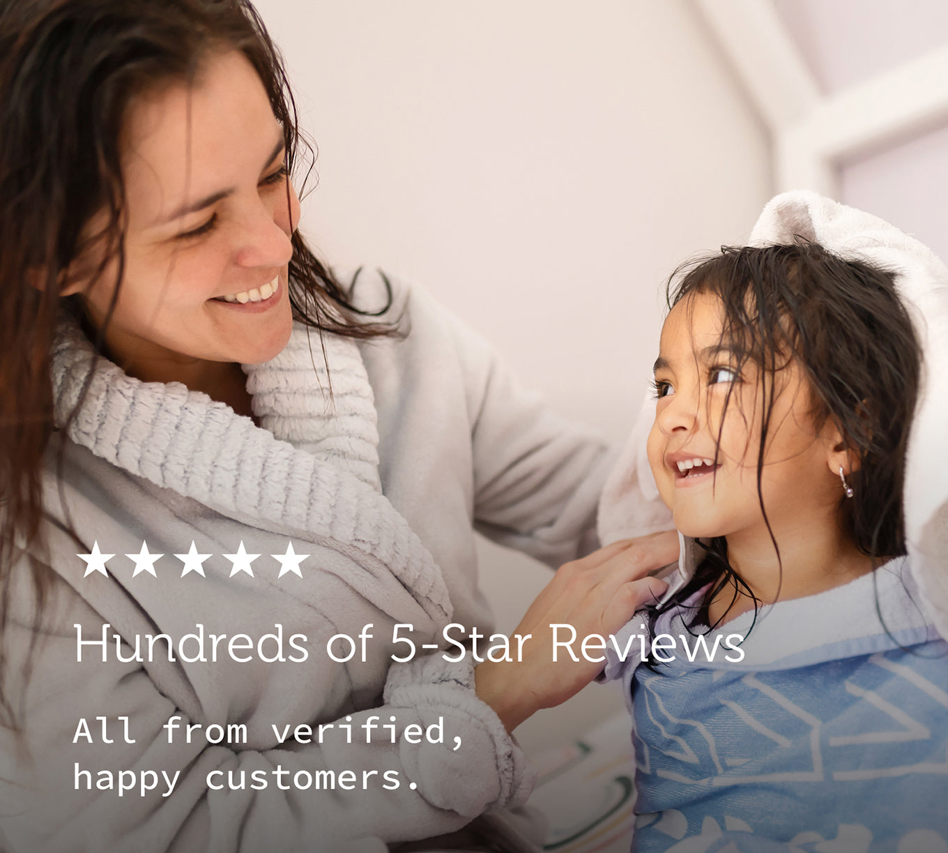 A photo of a mother and daughter, freshly showered, smiling, and wrapped in towels. The text reads: 