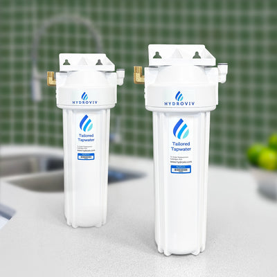A photo of two Hydroviv drinking water filters sitting on top of a table. The background is blurred.